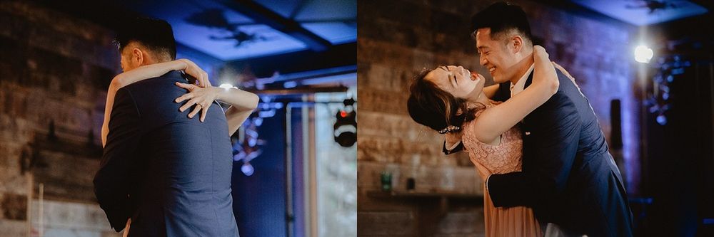 Joyful dance sequence captured in a rustic venue with dramatic lighting effects.