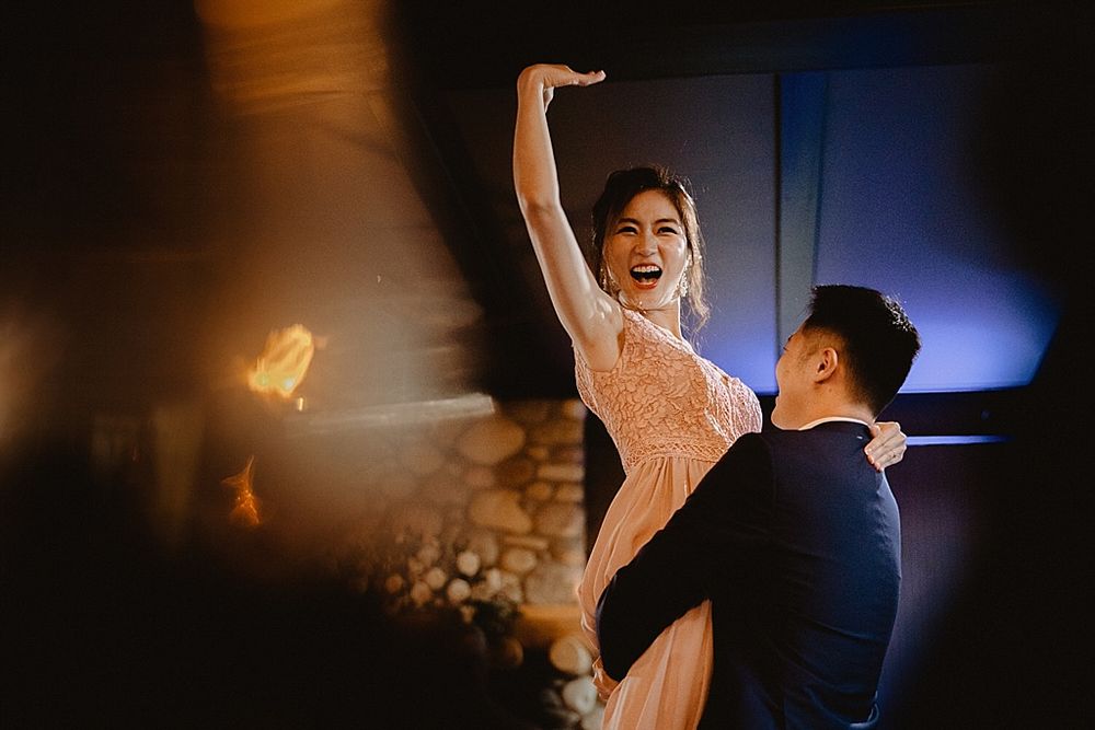 Dramatic dance scene with stark lighting against a dark background in a rustic venue.