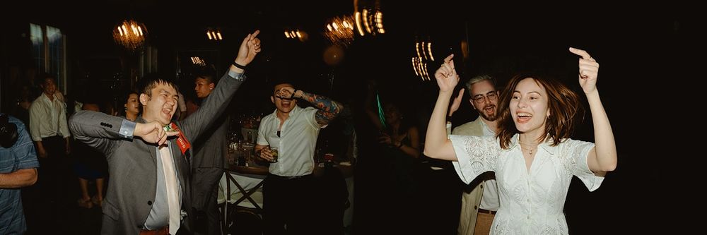 Wedding guests dancing with raised arms in a joyful celebration at night.