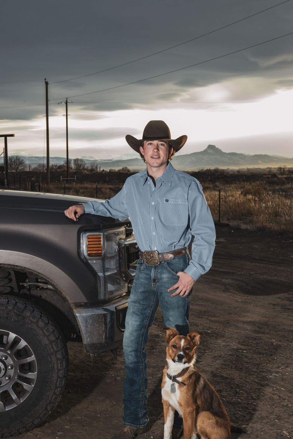 Western ranch scene with pickup truck, cowboy and loyal dog companion.