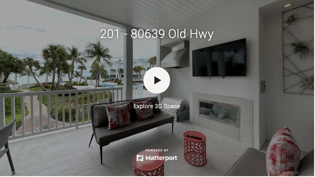 Modern lanai with outdoor seating and ocean views through palm trees.