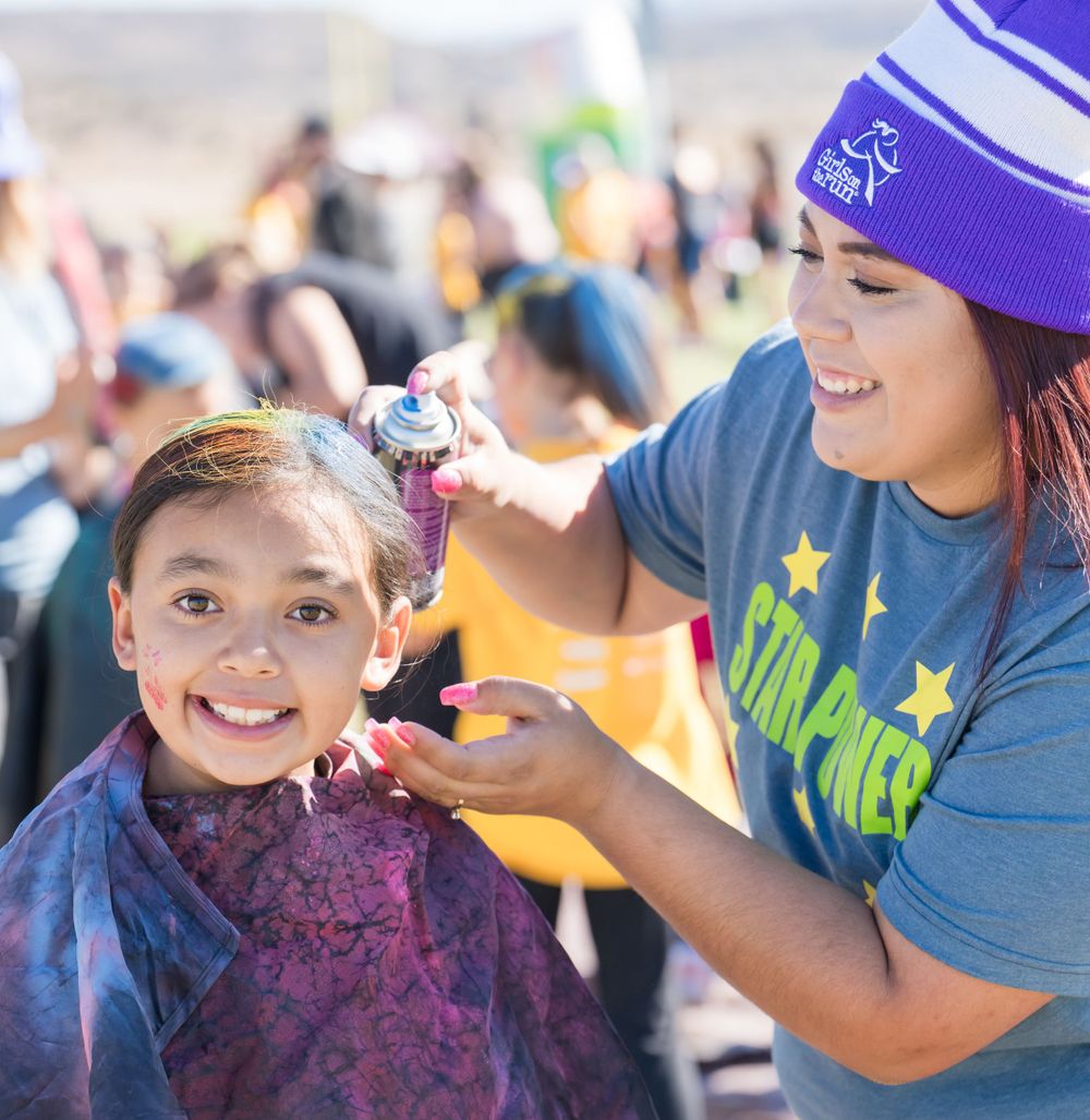 Volunteer paints girls hair at 2023 Girls On The Run photograph by Sean Openshaw