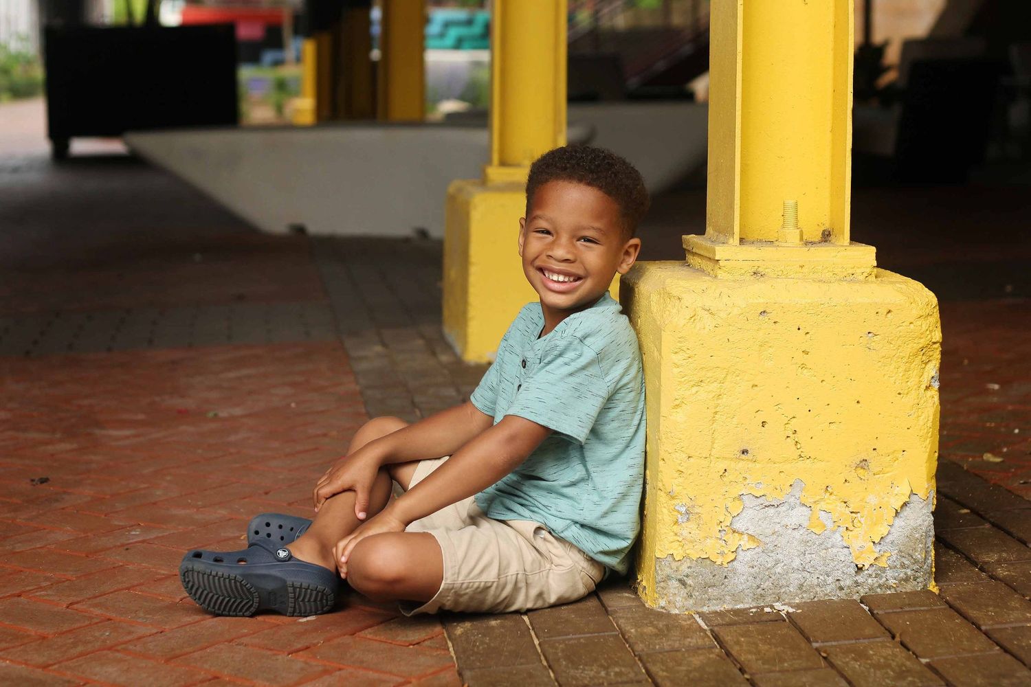happy child smiling at revolution mills in greensboro by victoria leigh photography