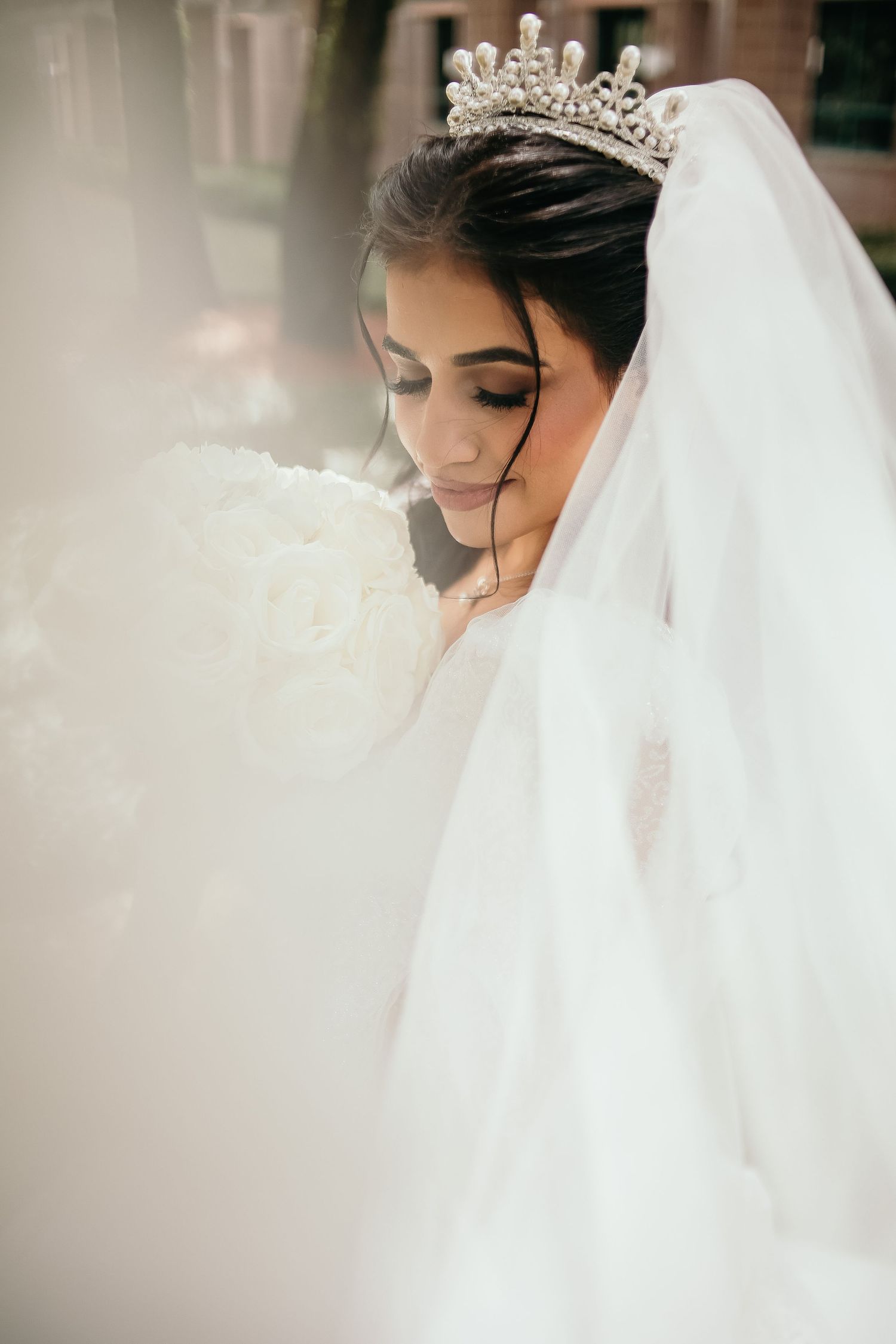 Ethereal bridal portrait featuring delicate veil and sparkling tiara.