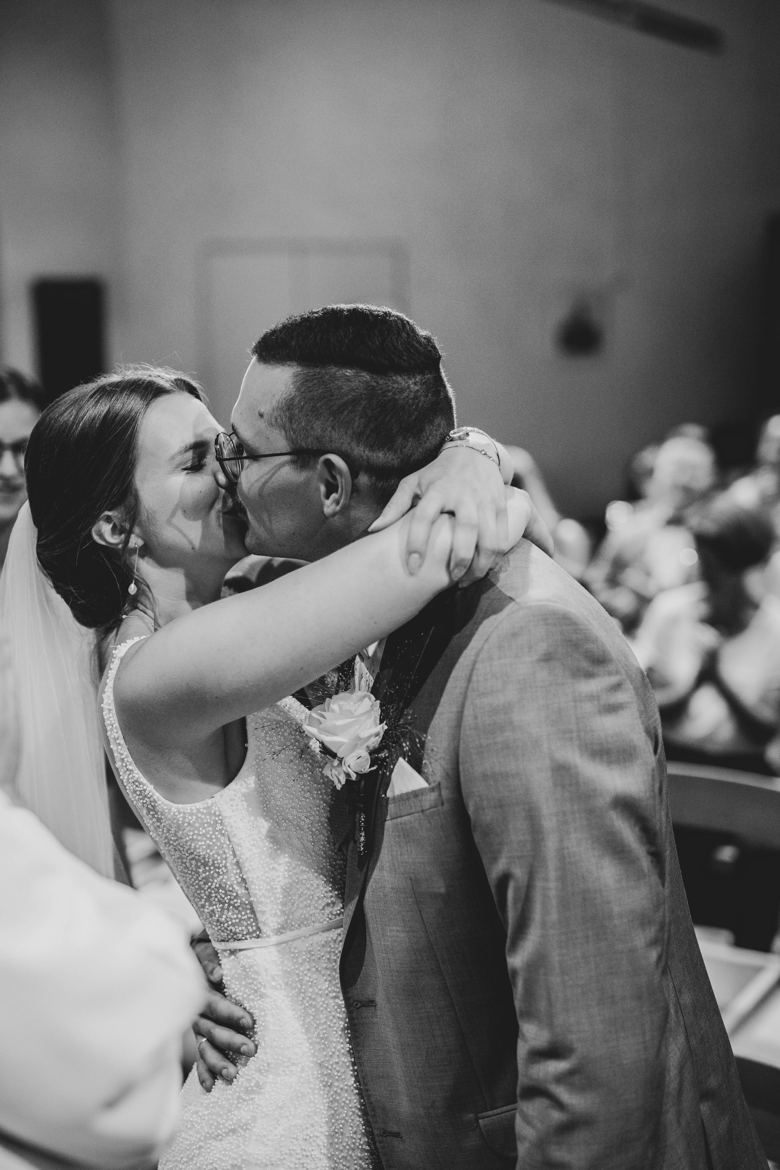 Intimate black and white wedding moment captured during ceremony.
