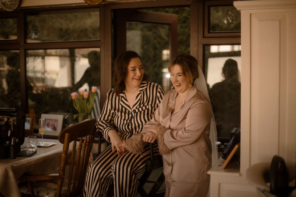 Two people sharing a moment in cozy indoor setting with natural lighting.