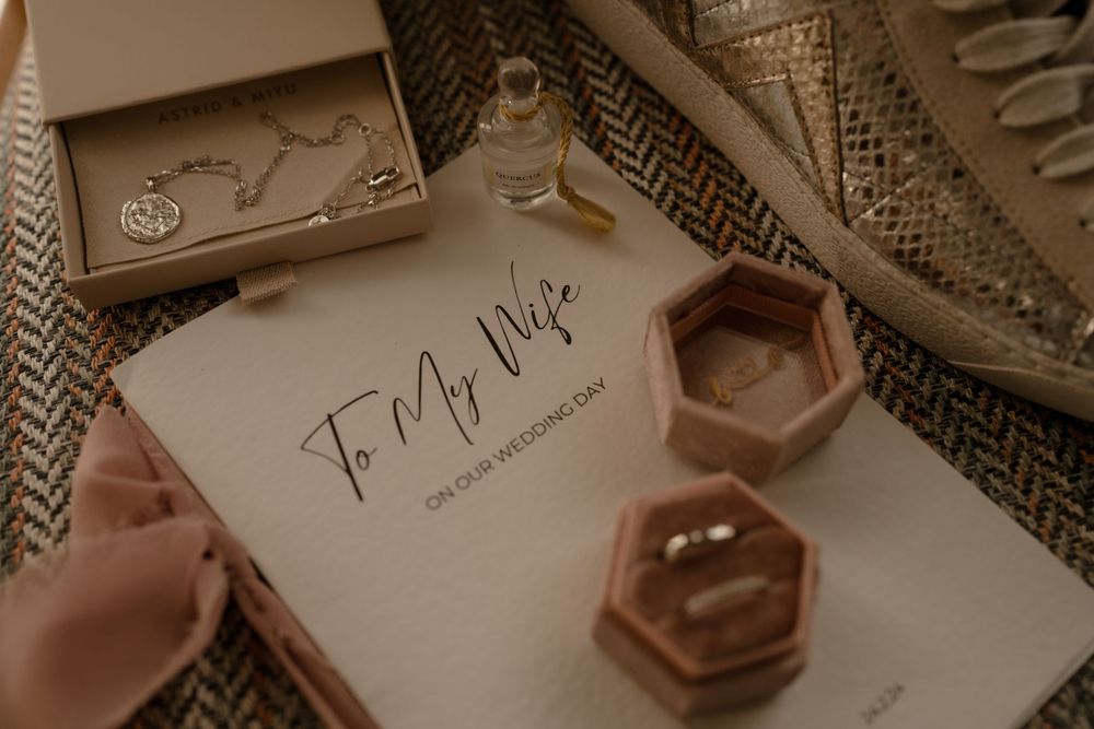 Wedding details featuring hexagonal ring boxes and handwritten notes.