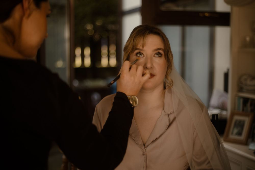 Makeup application in progress during a preparation session.