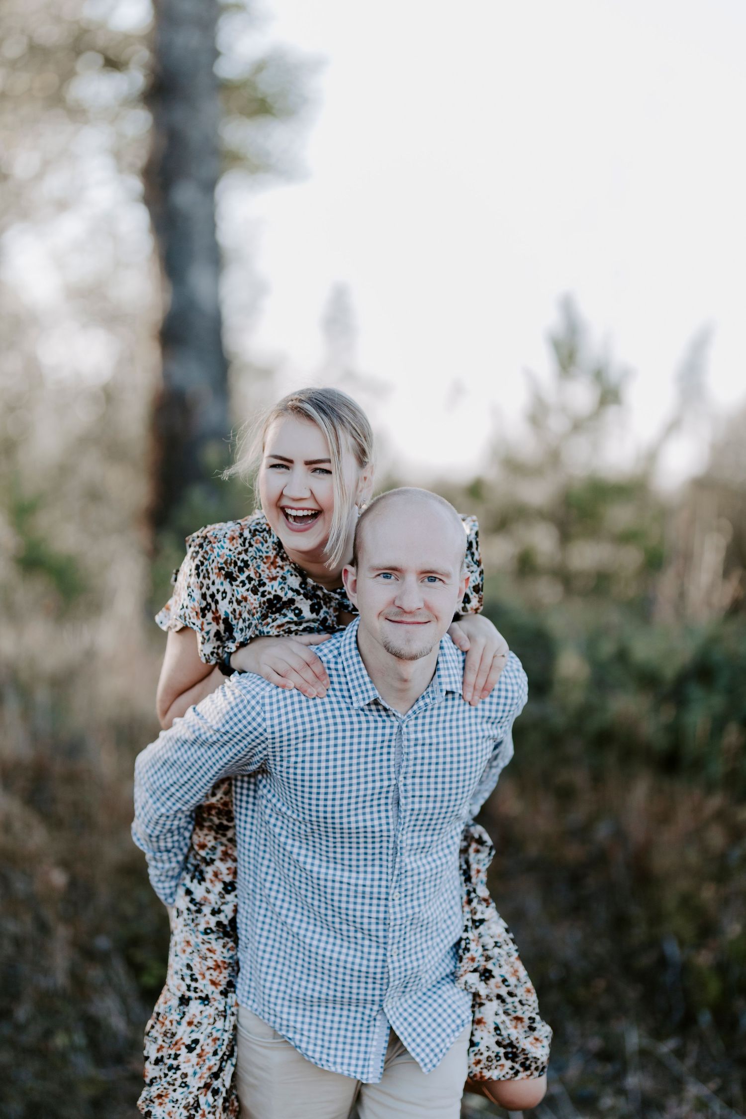 Playful piggyback ride in outdoor setting with natural lighting.