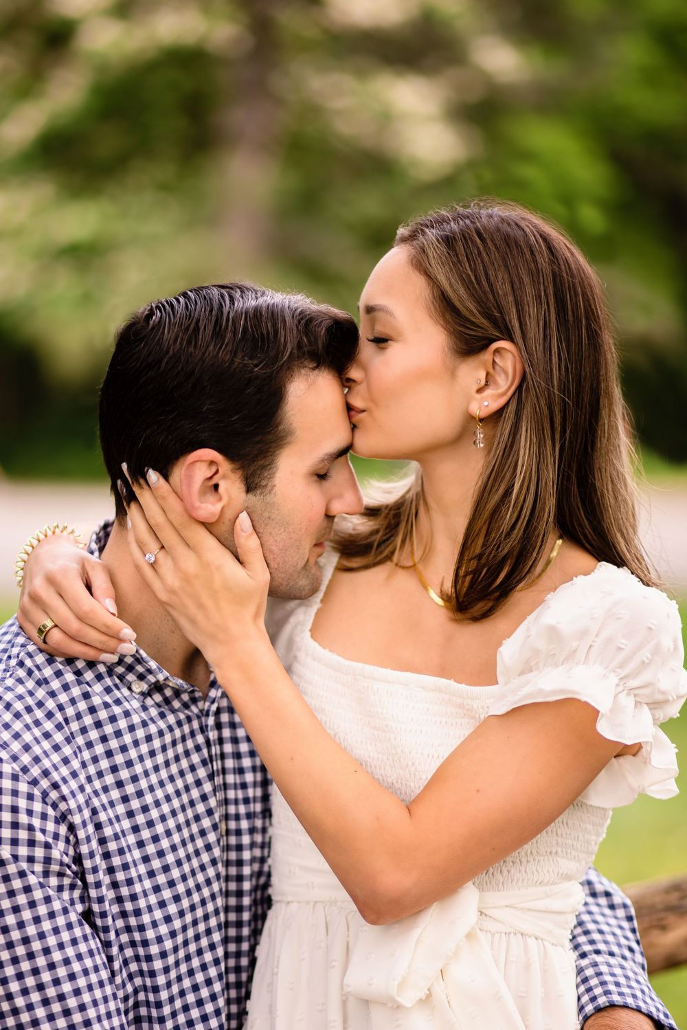 Romantic couple sharing an intimate moment outdoors in casual attire.