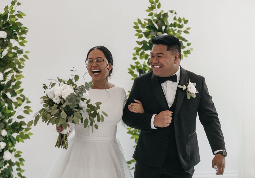 Natural light bright chapel wedding bride and groom exit natural green and white flowers
