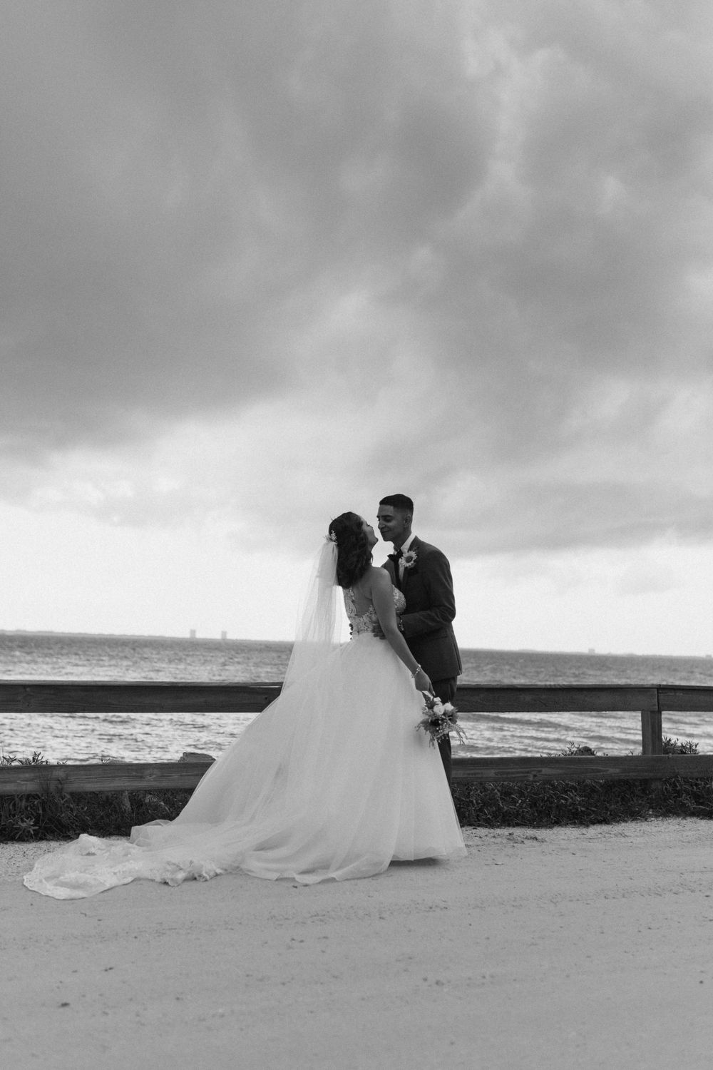 Tropical wedding bride and groom with lush palm trees and sandy beach