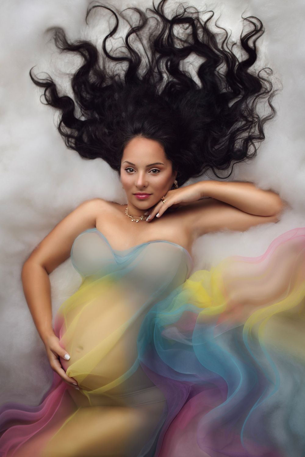Dreamy portrait with flowing hair and colorful fabric details.