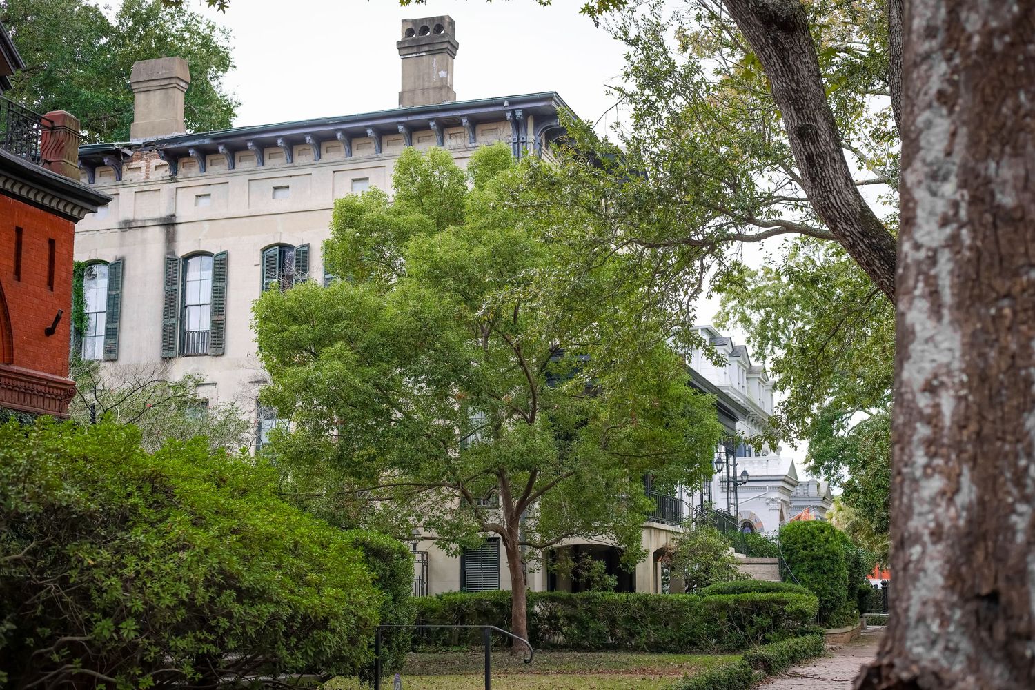 A stately historic mansion with green landscaping and classic architectural features.