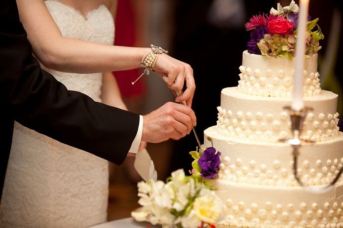 Seven close-up photos show various stages of a wedding cake cutting tradition at a wedding reception celebration.