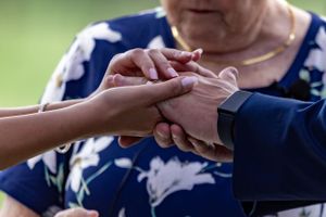 Close-up of hands exchanging rings during wedding ceremony.