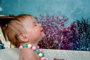 Child portrait with teal background and spring blossoms.