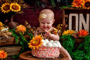 Rustic autumn scene with sunflowers and festive decorations.
