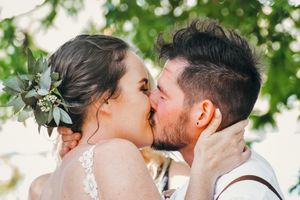 Intimate moment captured between newlyweds during their outdoor wedding ceremony.