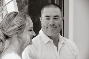 Black and white candid moment of a couple sharing a laugh.