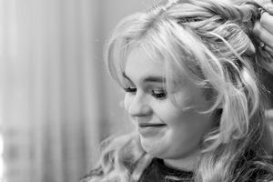 Black and white portrait showing an elegant hairstyle with braided details.