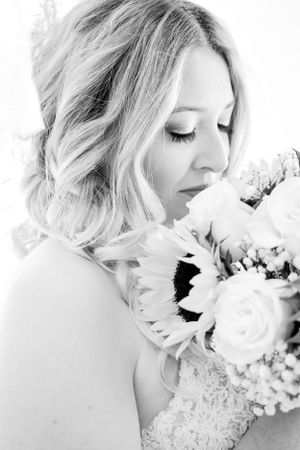 Black and white portrait with bridal bouquet featuring sunflowers and roses.