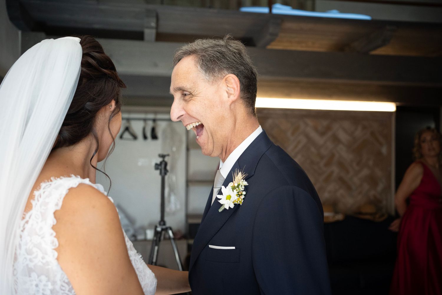 An emotional wedding day moment shared between two people in formal attire.