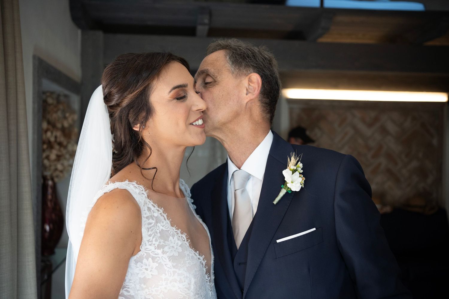 Intimate wedding moment captured in an elegantly decorated interior setting.