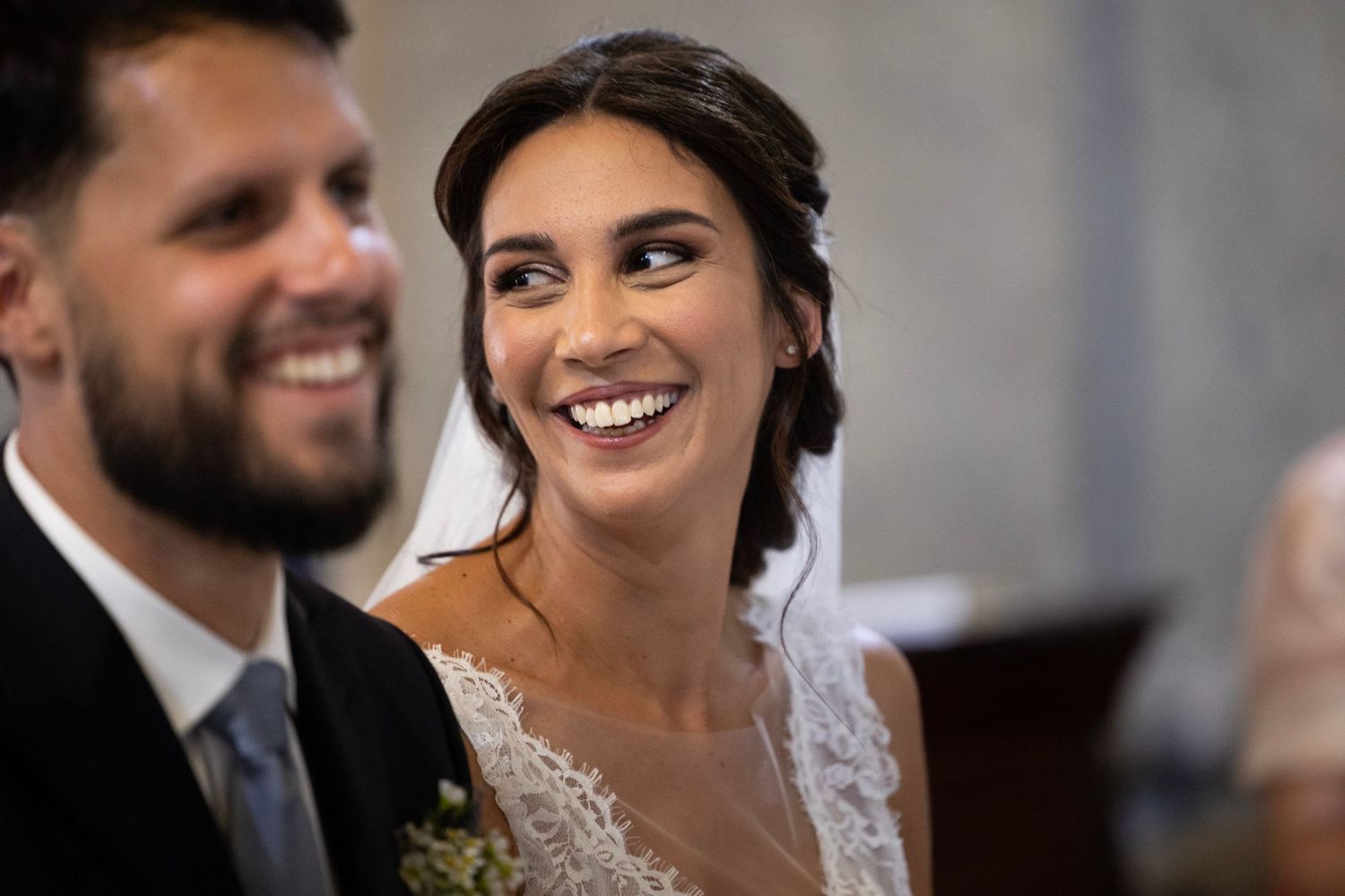 Joyful wedding ceremony moment in a church with natural light and smiles.
