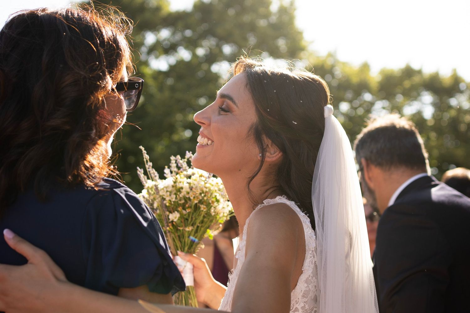 Emotional outdoor wedding moment captured in golden sunset light.