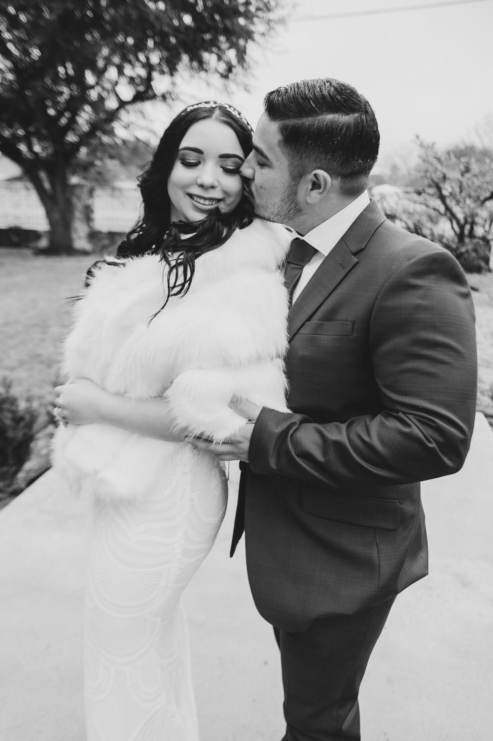 Black and white portrait of newlyweds in an intimate outdoor moment.