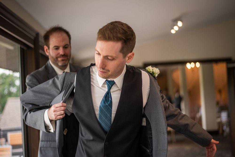 groom and best man getting ready before wedding ceremony at Stratford Country Club