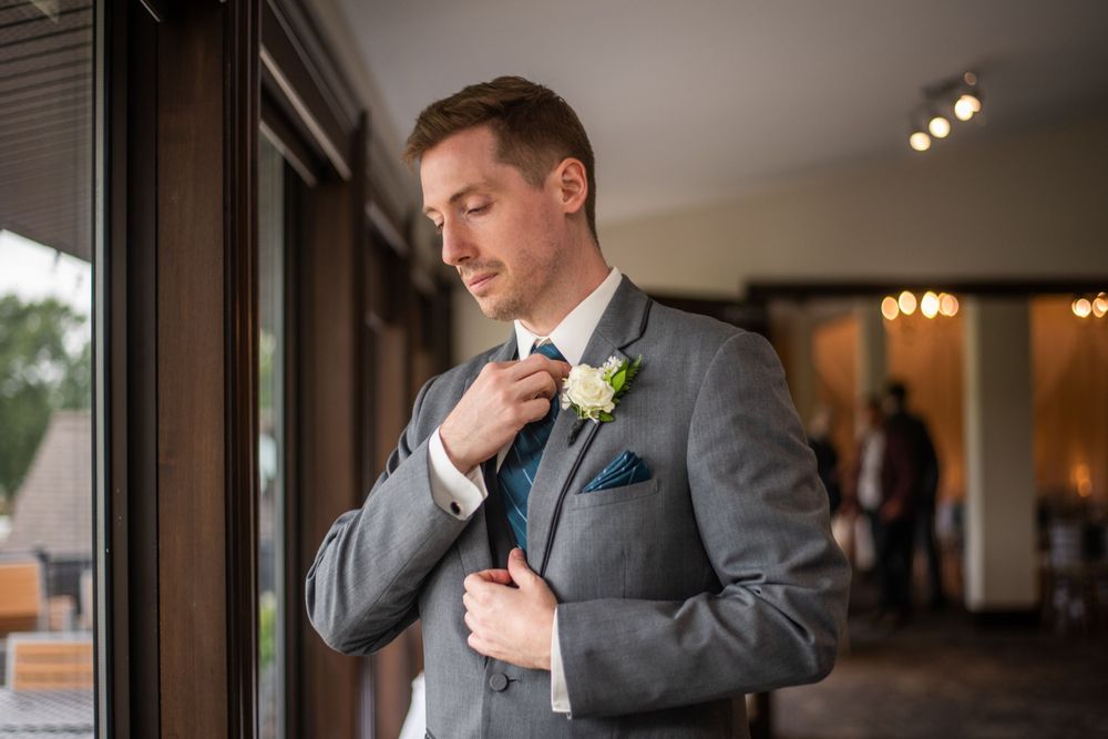 groom getting ready before wedding ceremony at Stratford Country Club