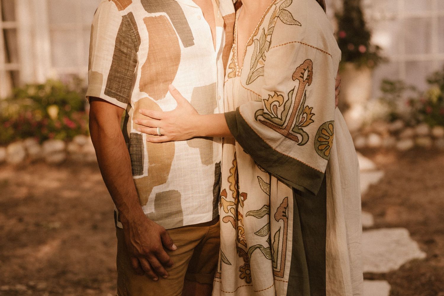 Close-up portrait of couple in matching light-colored patterned shirts.