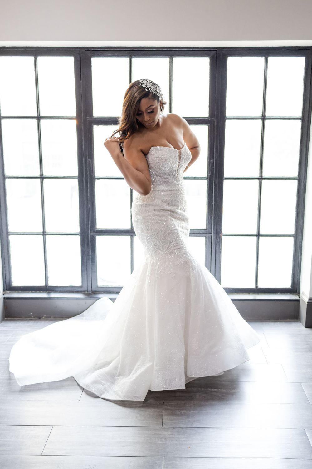 Classic mermaid wedding gown with detailed bodice and sweeping train photographed in natural light.