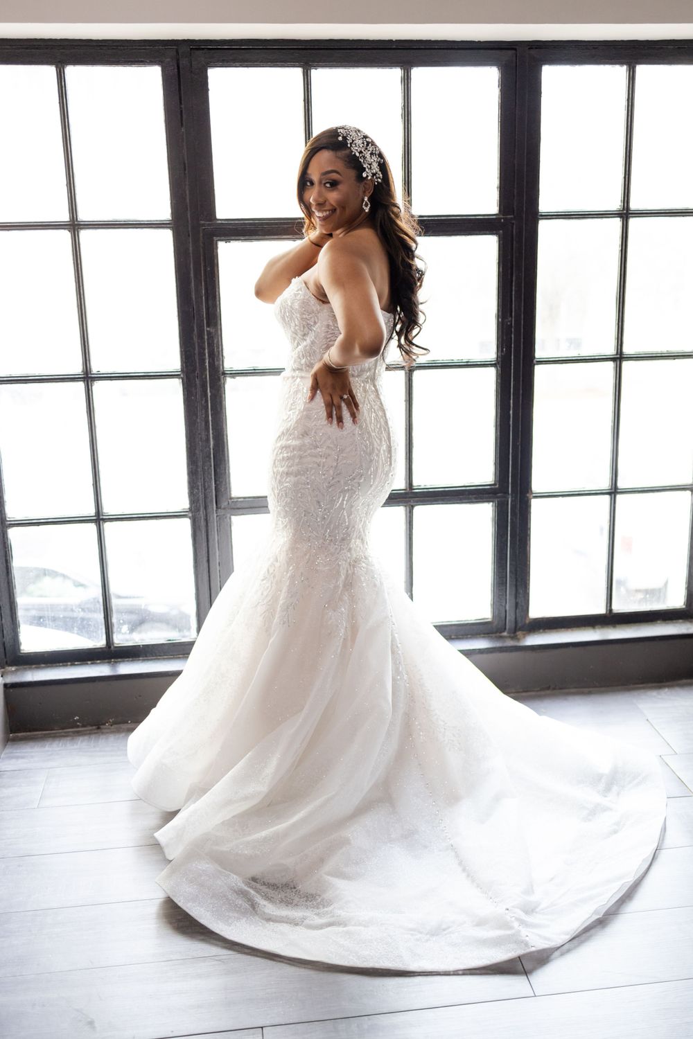 Side profile of strapless mermaid wedding gown with delicate lace details.