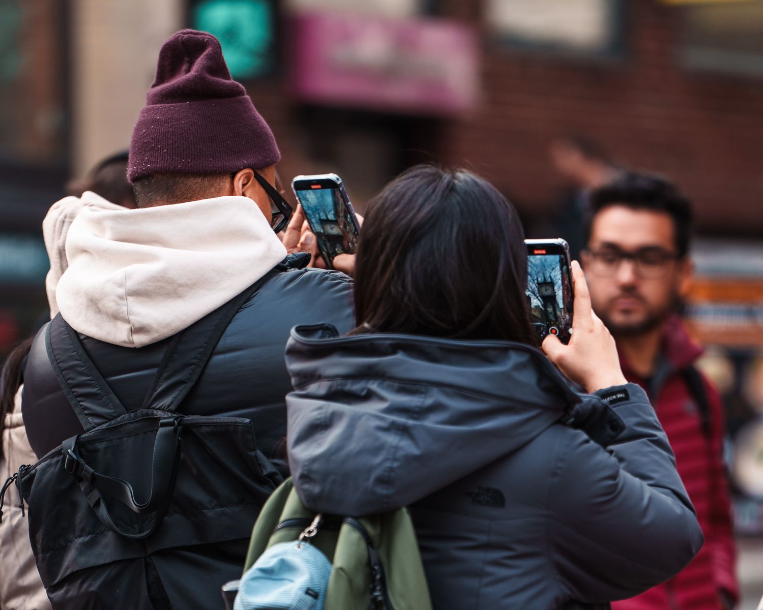 A man and a woman recording the Steam Clock in Gastown, Vancouver, British Columbia, Street Photography.