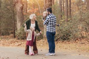 A playful moment captured on an autumn path surrounded by fall foliage.