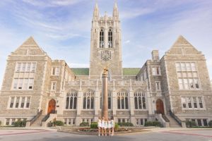 Gothic university building with stone architecture and towers photographed from the front entrance.