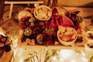 Festive table setting with red berries and floral arrangements illuminated by soft lighting.