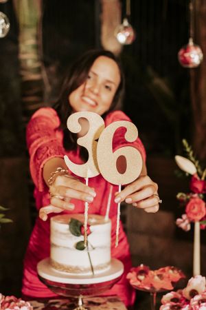 A celebratory scene with a birthday cake adorned with number 36 toppers and pink floral decorations.