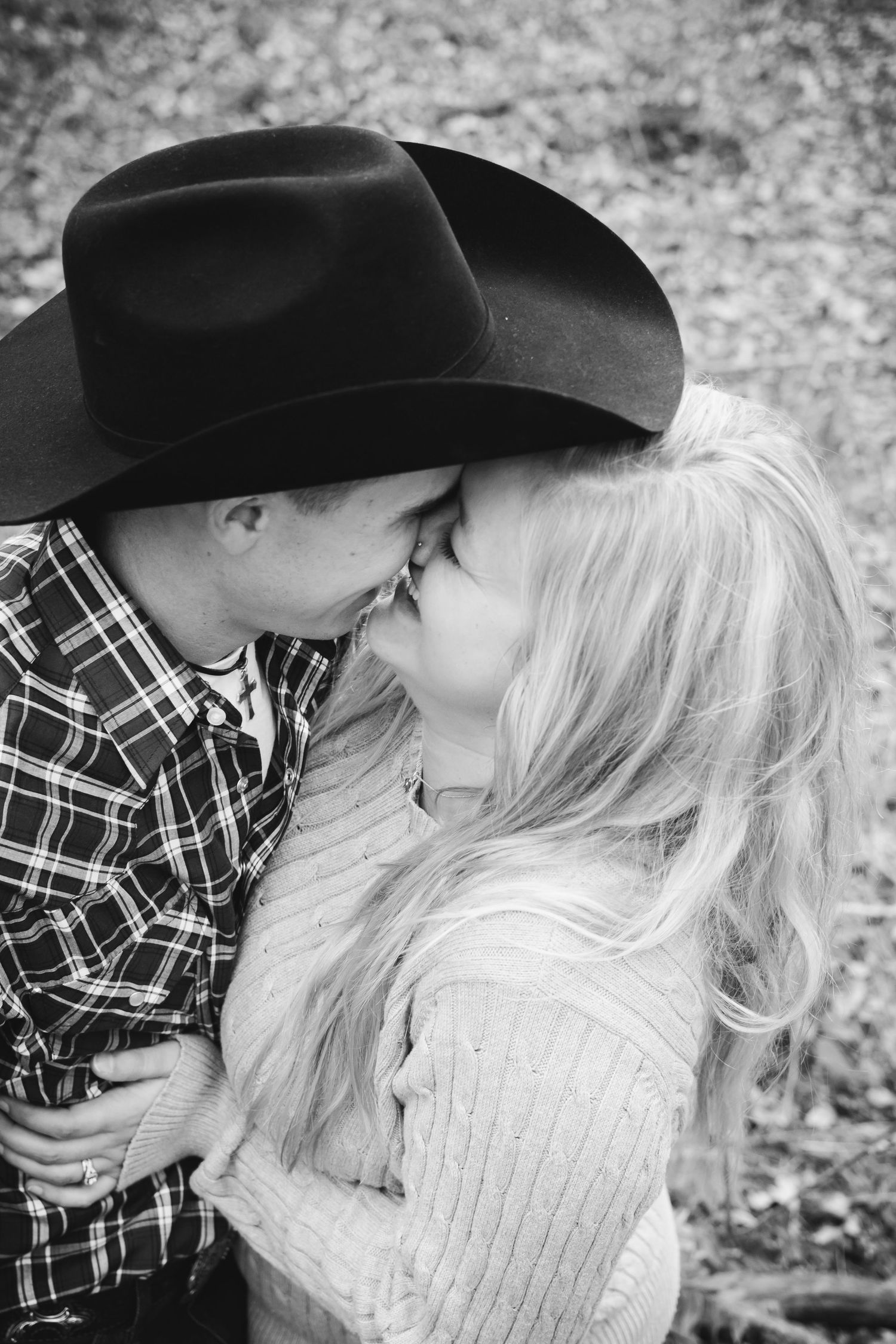 A tender black and white photo of a couple sharing an intimate moment while wearing western attire, Hagerman Wildlife Refuge, Texas