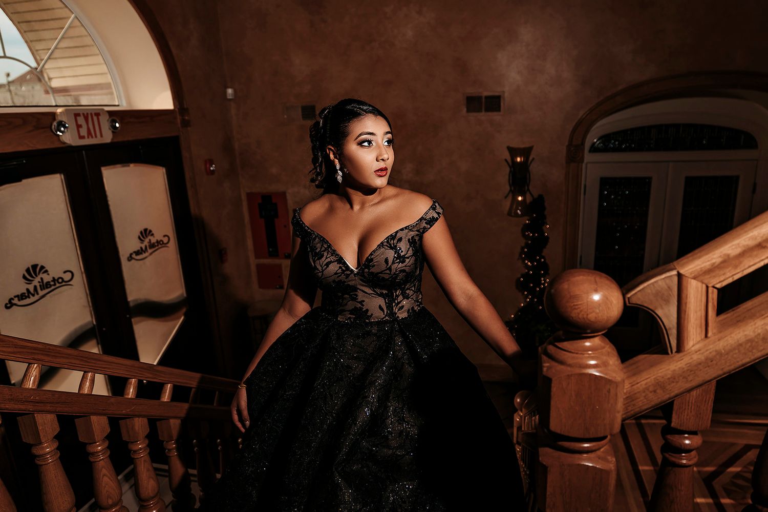 Artistic boudoir photography in moody lighting with vintage furniture.