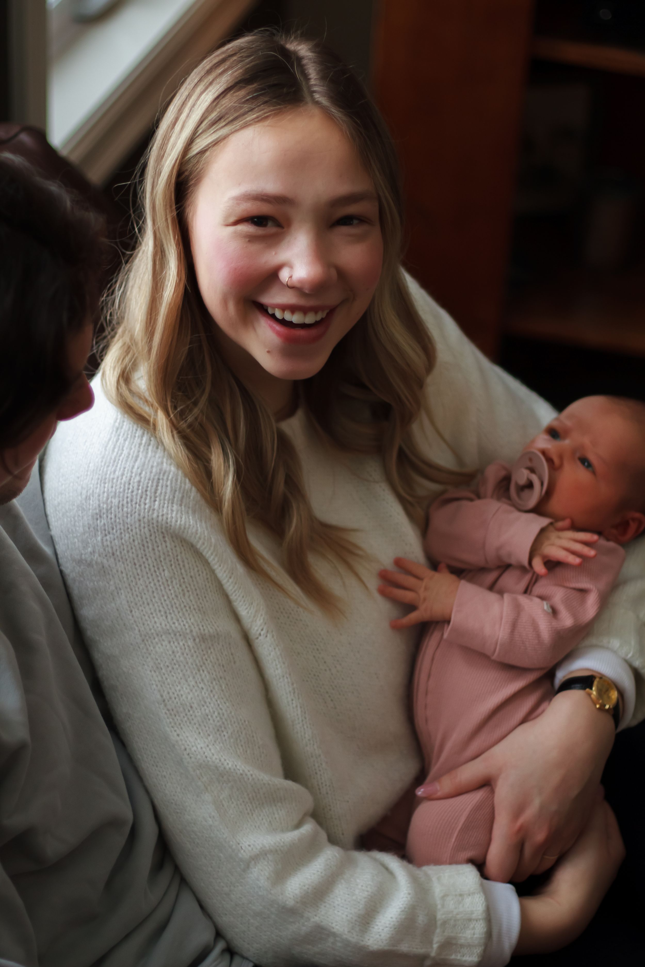 Above shot of mom holding newborn during lifestyle newborn session.