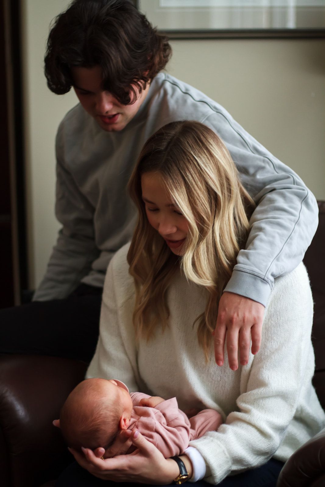 New parents admiring baby duing lifestyle newborn session.