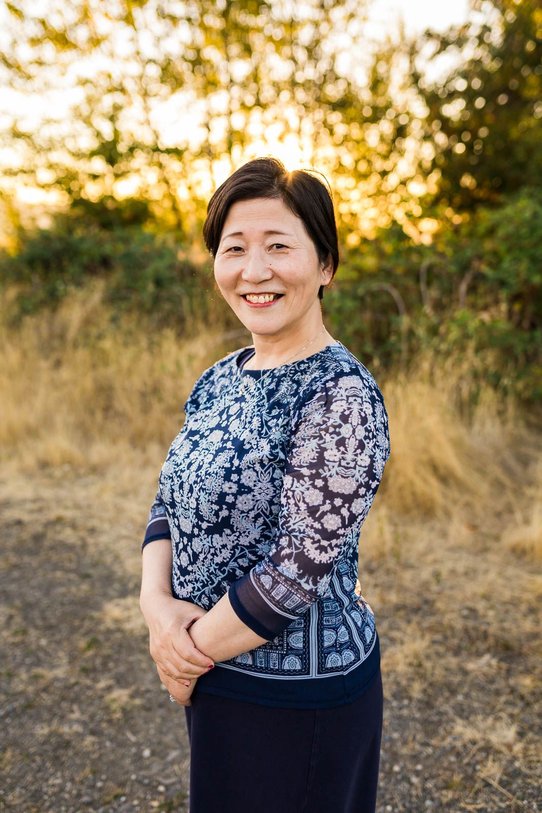 Headshot of mother smiling at the camera at sunset