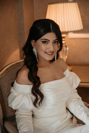 Classic bridal portrait featuring elegant off-shoulder gown and romantic lighting.