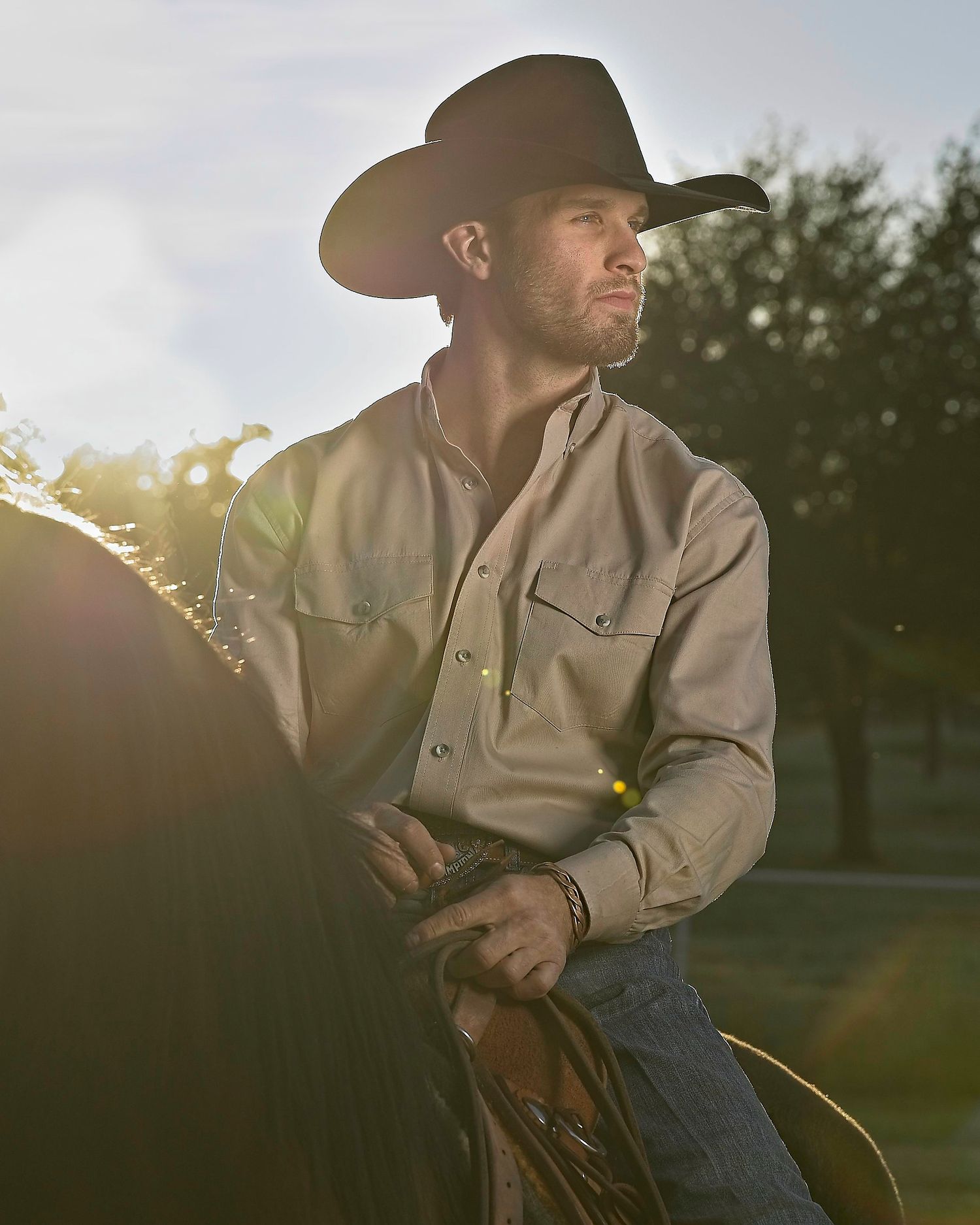 Leighton Berry looks to the side as he rides his horse through his training ring.