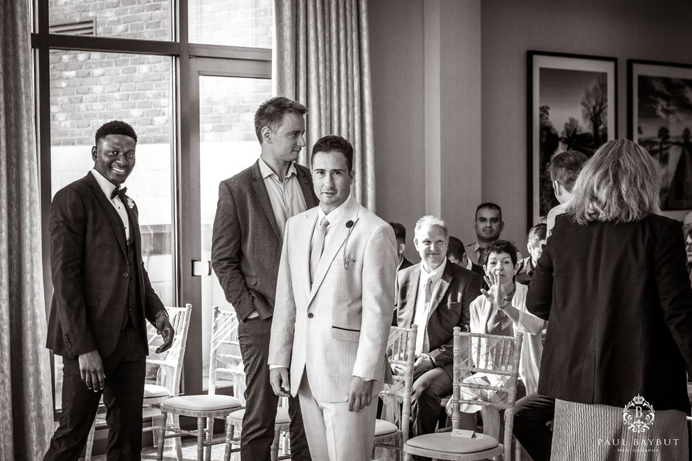 Black and white photo of wedding ceremony setup with guests seated.