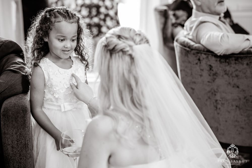 A black and white candid wedding moment capturing an intimate conversation.